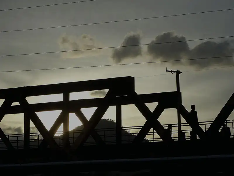 A Kampot river bridge in silhouette at the end of the day